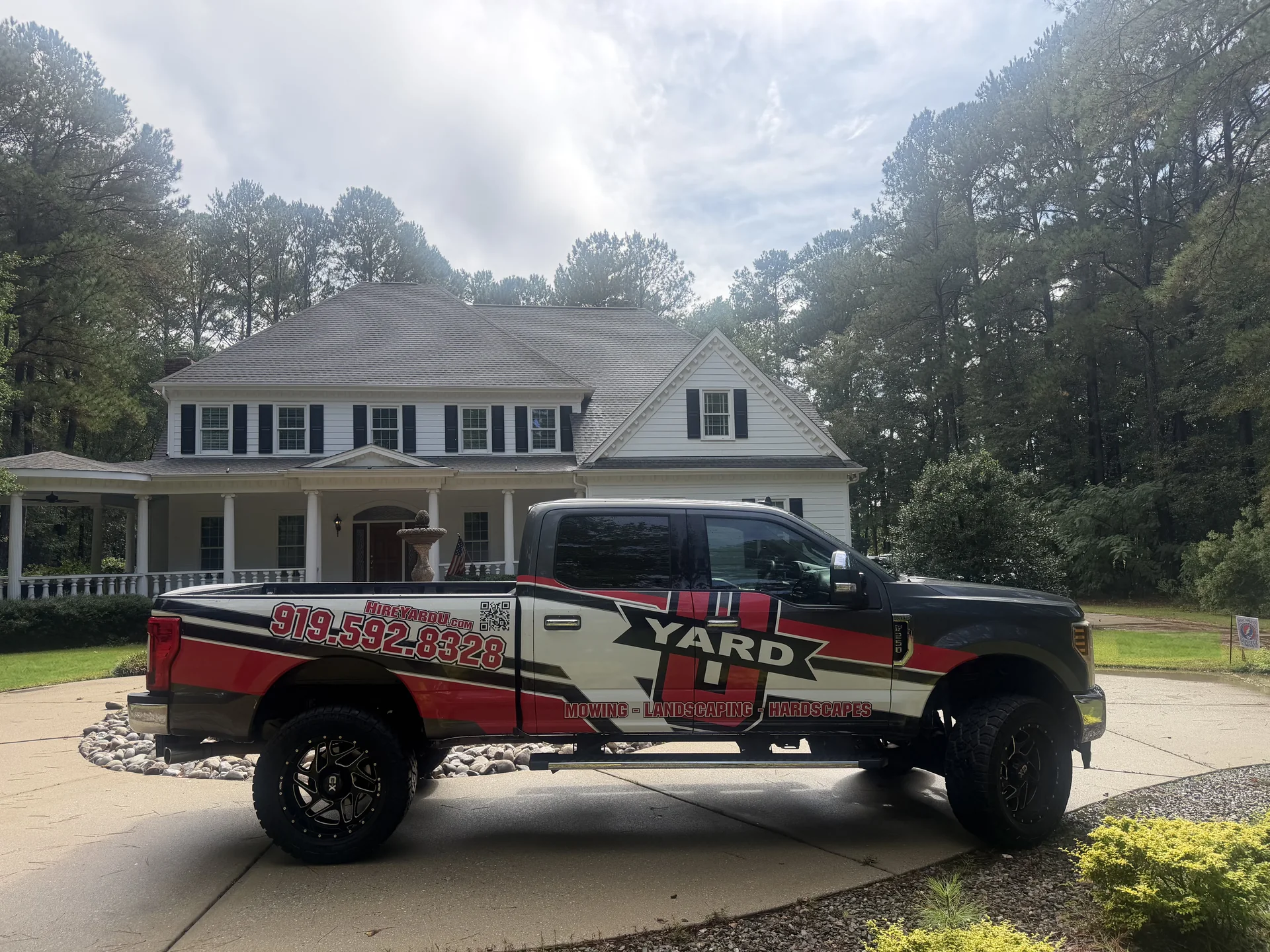 YardU’s branded landscaping truck parked in a residential driveway