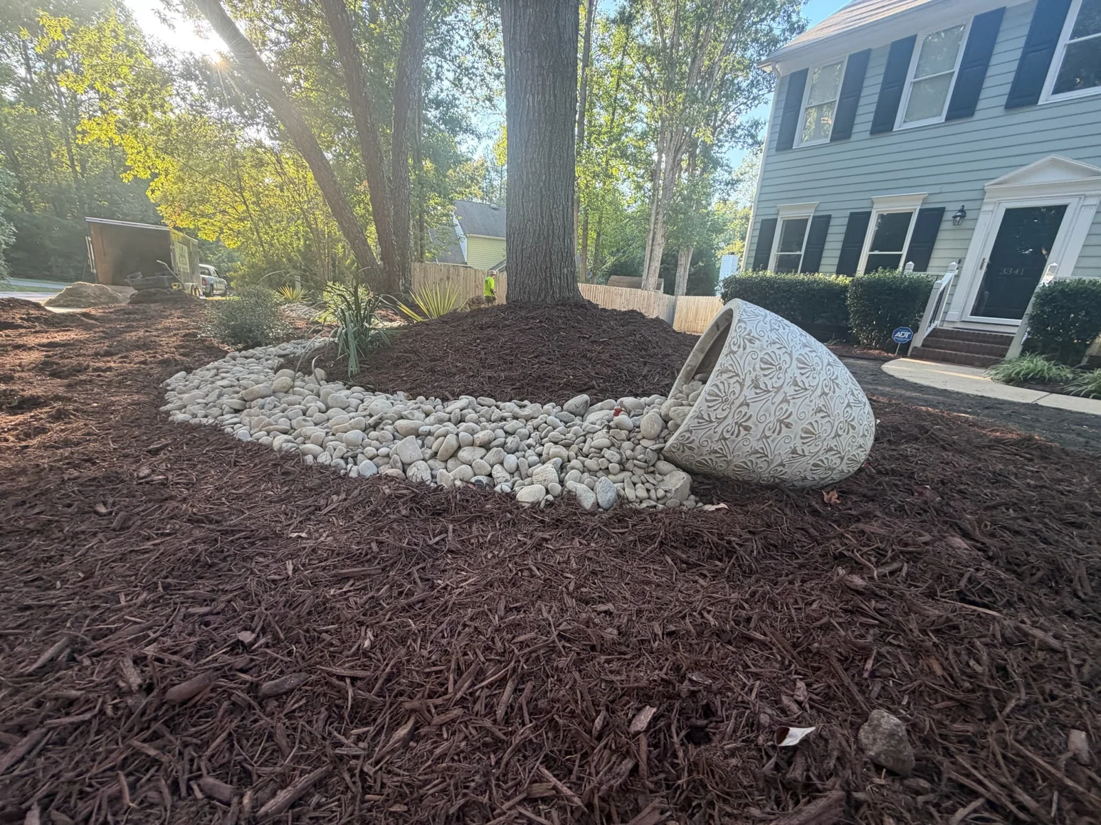 White decorative rock bordering a tree bed in YardU’s shared project album